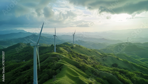 Beautiful green hilly landscape with wind turbines, aerial view. Sustainable energy , ecological power production