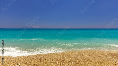 Scenic view of sea waves against the beach on a sunny day