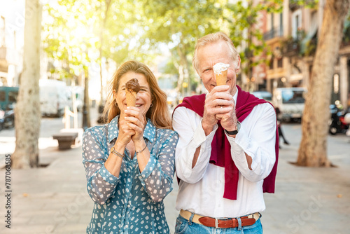 Senior couple eating ice cream and having fun in Barcelona