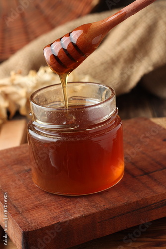 jar of honey and wooden spoon © cintiaynoue