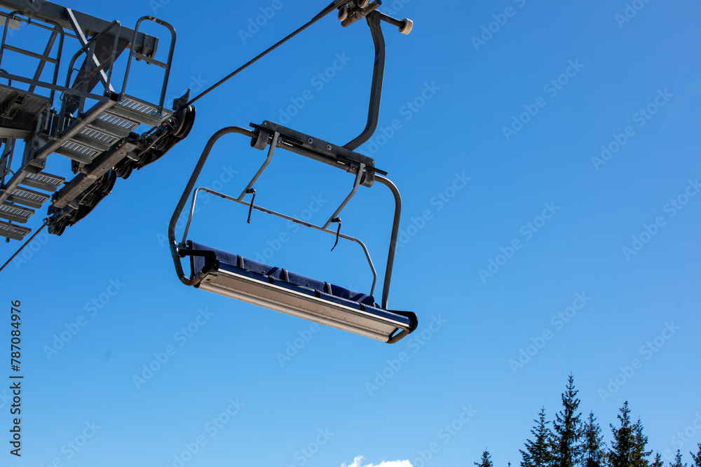 ski lifts against the background of a blue sky with clouds. Ski resort Active recreation ski lifts against the background of a blue sky with clouds. Ski resort Active recreation