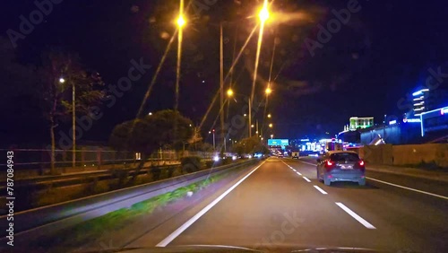 a car driving down a street at night