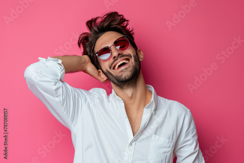 Photo of funky attarctive guy dressed white shirt dark glasses smiling having fun isolated pink color background . photo on white isolated background photo