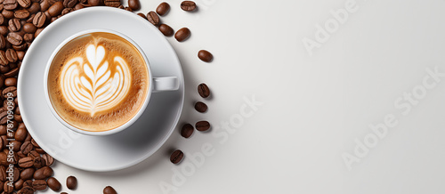 White ceramic cup with cappuccino top view on white background with copy space