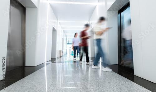 People walk in the elevator corridor