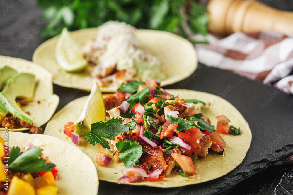 set of delicious fresh colorful tacos on a dark background set of delicious fresh colorful tacos on a dark background