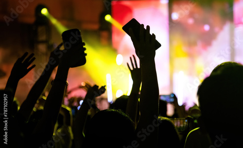 People using mobile phone camera at a concert