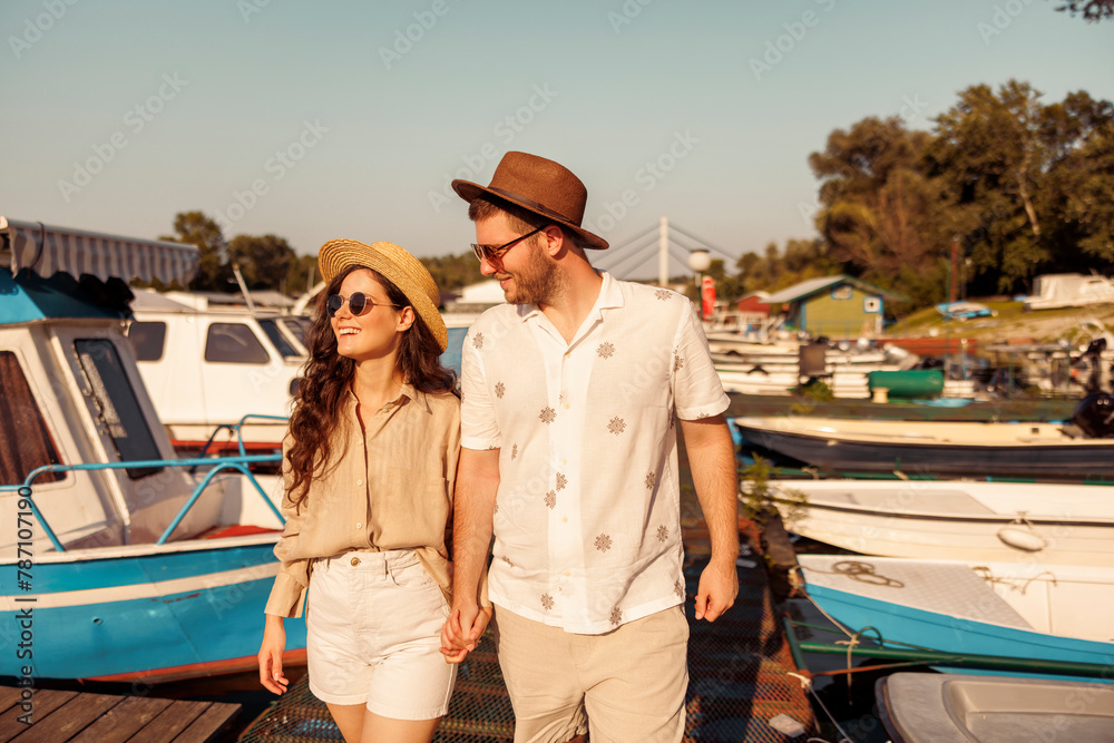 Couple taking a walk on river docks in the city marina