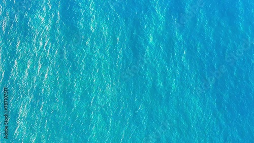 Atlantic ocean texture. Turquoise sea water background. Calm blue sea waves cover the landscape. Flowing clean water in motion. Close up of blue water surface in deep sea. photo