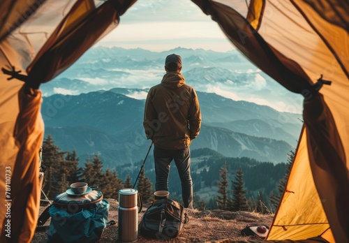 Man Standing on Mountain Top, Gazing Into Distance