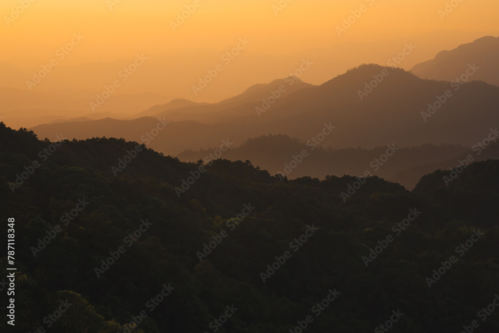 nature traveling with orange sky and layer of mountain with sunrise background