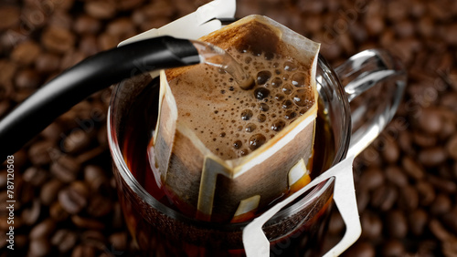 Pouring hot water in glass with drip coffee bag 
