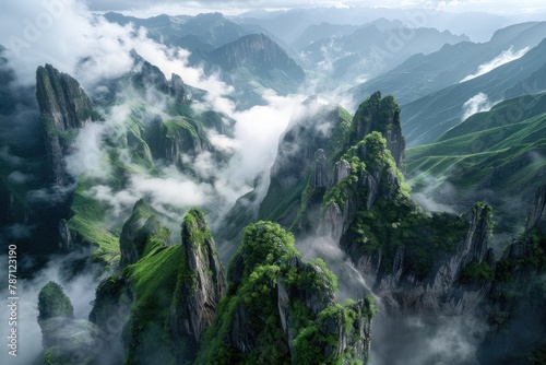 beautiful aerial shot from the sky of big natural green peeked mountains covered with white clouds and fog in the morning