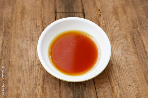 Phu Quoc Traditional Fish Sauce. Extract fish. Fish sauce in white bowl isolated. Authentic Phu Quoc Fish Sauce photo