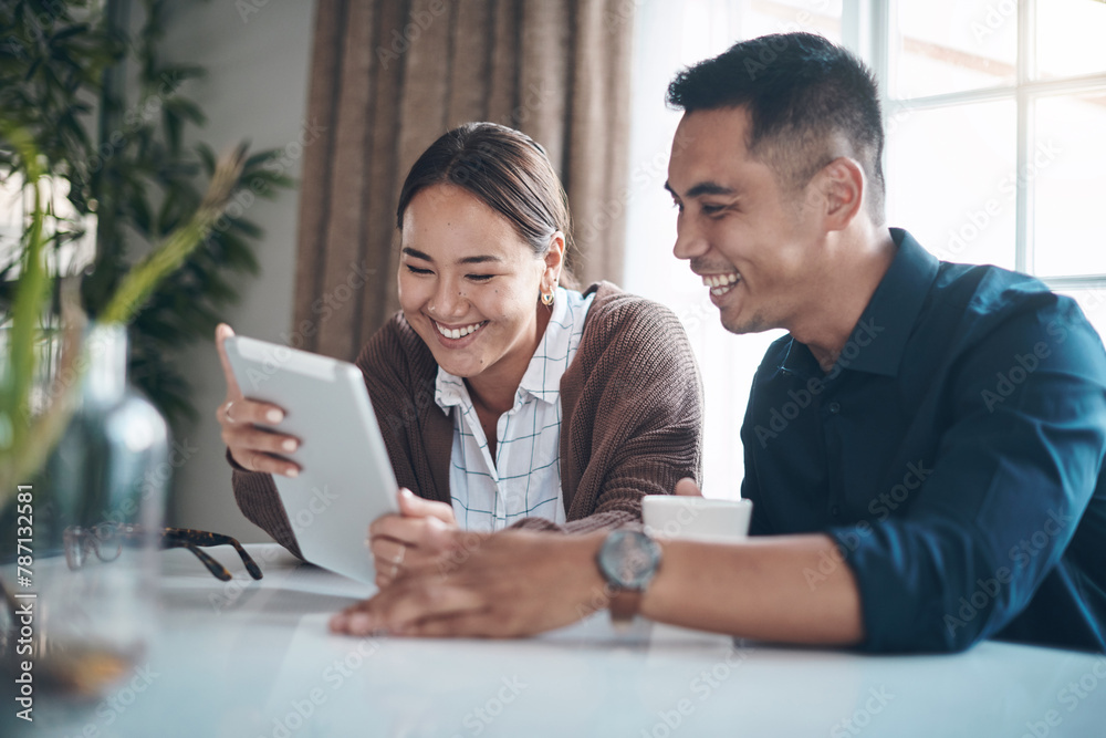 Tablet, smile and Asian couple networking in home on internet, social media or app with funny meme. Happy, laughing and young man and woman watching video on digital technology at house together. Tablet, smile and Asian couple networking in home on internet, social media or app with funny meme. Happy, laughing and young man and woman watching video on digital technology at house together.