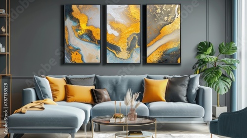 Triptych of abstract golden and blue fluid art paintings on a dark wall above a gray couch