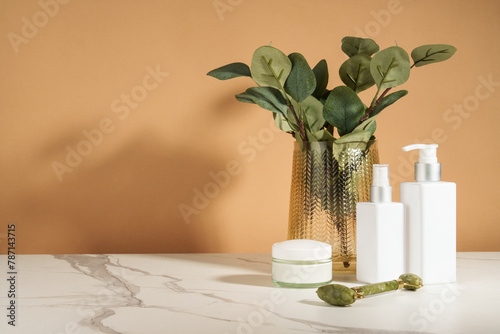 Bathroom with beauty products. Natural cosmetic, towels and vase with flowers.