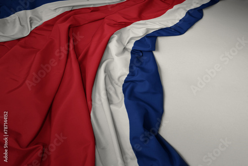 waving national flag of costa rica on a gray background.