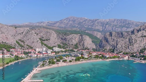 Omis, Croatia: Aerial view of famous Mediterranean town and summer resort by Adriatic Sea, Punta Beach (Velika plaža) summer day with clear blue sky - landscape panorama of Europe from above
 photo