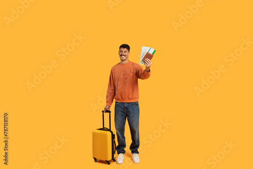 Travel ready guy with suitcase and passport