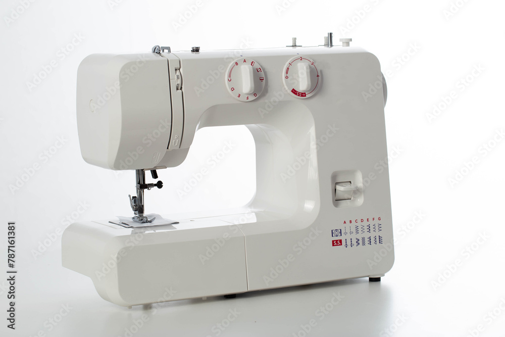 Automatic modern sewing machine with overlock on a white background, isolate. Studio concept. Tailoring services
