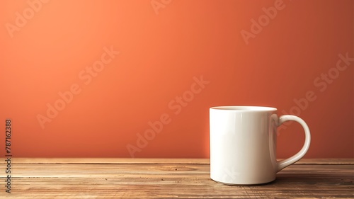 Blank white mug on wooden table isolated on orange colour background