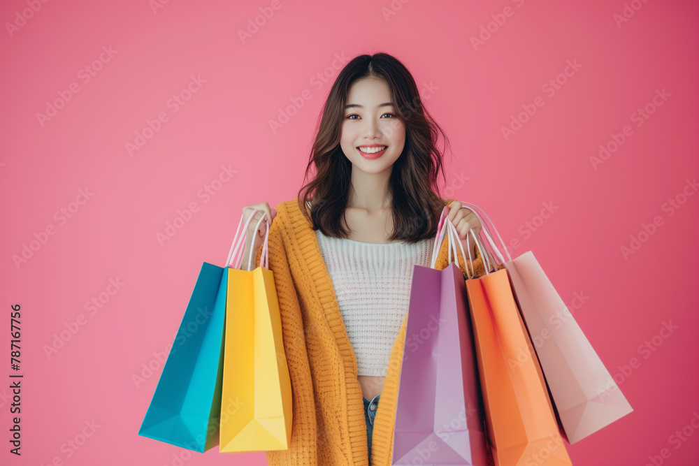 Studio shot of happy woman with shopping bags. Purchases, online shopping, sale concept. Copy space