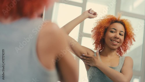 Woman checking her armpit skin, pleased with antiperspirant, sweat prevention photo