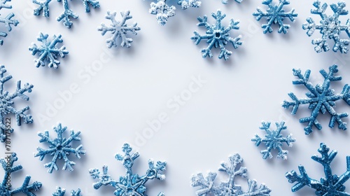 Blue frosted snowflakes on white, winter holiday invitation background.