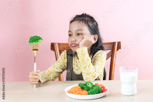 Asian Little Cute Girl Refuses to Eat Broccoli Healthy Vegetables.