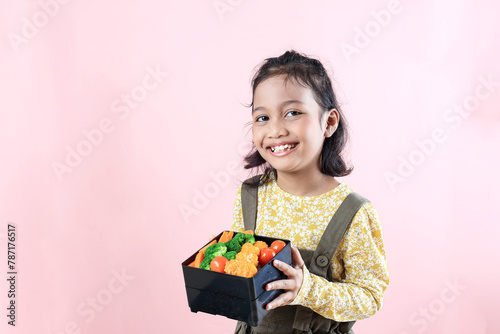 Little Female Asian Kids Showing Her Lunchbox photo