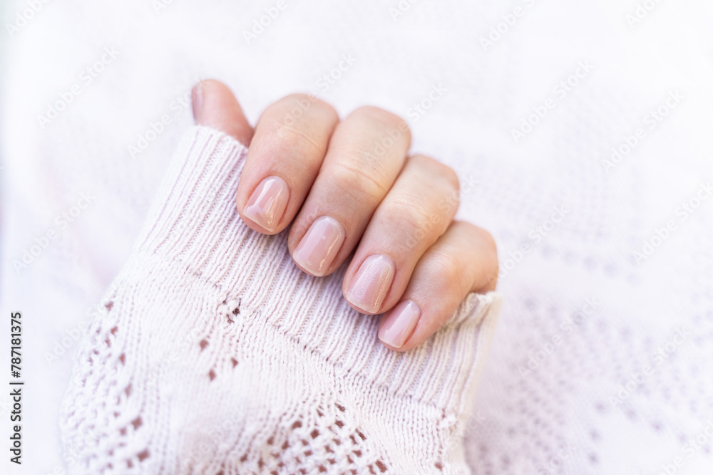 Maintained female nails. Beautiful and natural manicure. Gel polish. Cleaned, shaped and varnished nails. Nail care.