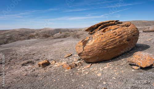 Large round red concretion on the horizon at Red Rock Coulee near Seven Persons, Alberta, Canada photo