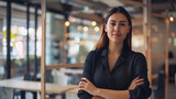 Proud arms crossed and confident businesswoman standing alone in a modern office Young female business owner smiling in a corporate workplace Happy and successful lady at work with cop : Generative AI