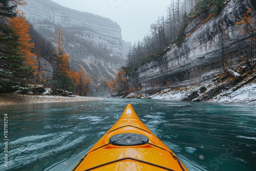 Single bright yellow kayak navigates the peace of a mountain river surrounded by autumn's tranquility