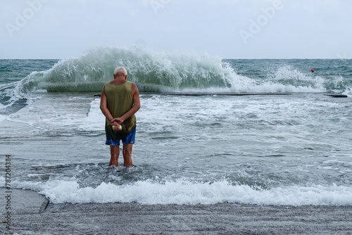 person meditating in front of a wave