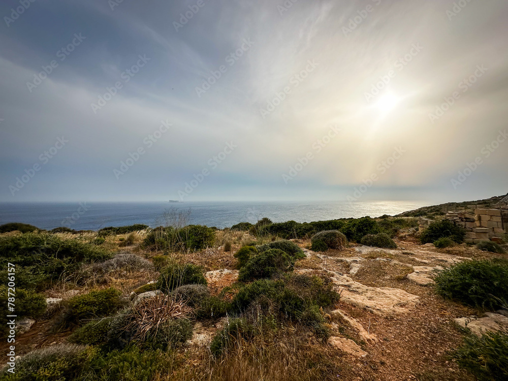 A tourist trip on Malta to a beautiful place in nature, the Blue Grotto cliff and Hagar quim temples, where there is a magnificent view from the rocks on the beautiful azure sea