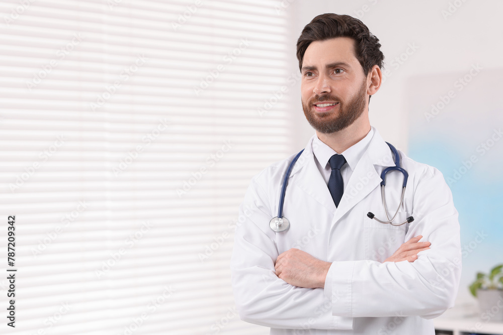 Medical consultant with stethoscope in clinic, space for text Medical consultant with stethoscope in clinic, space for text