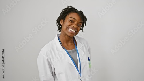 Cheerful young black woman in a labcoat making a comical fish face, crazy eyes and puckered lips against a white isolated background photo