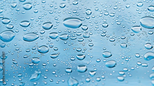 Air bubbles in light blue liquid background with water droplets, refreshing aqua backdrop