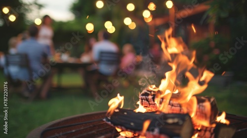 Blurry background of a backyard barbecue with families gathered around a cozy bonfire and enjoying each others company in the warm glow. . photo