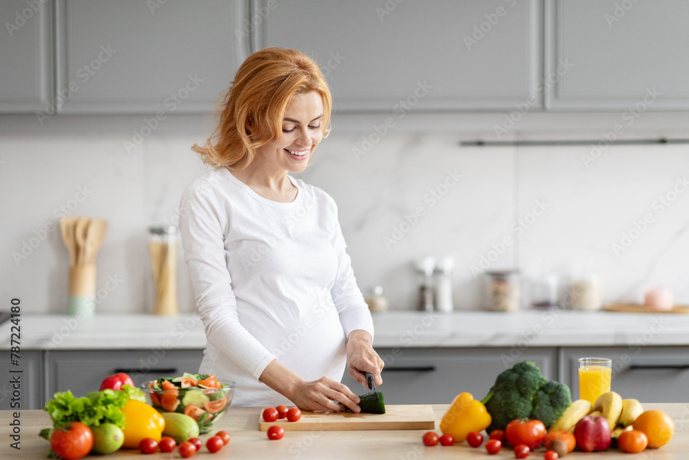 Pregnant woman preparing salad in modern kitchen Pregnant woman preparing salad in modern kitchen