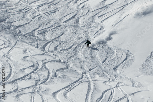 Skier skiing in the Swiss alps off-piste in white snow