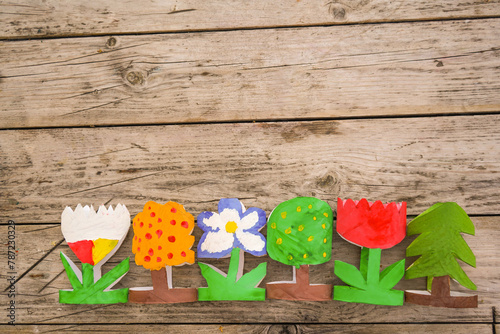 Kids craft trees and flowers out of recycling toilet paper roll, zero waste concept.