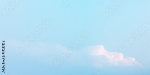 It's a hot day with the sun shining down on a blue sky filled with alternating small and huge clouds moving gently while the light from the sky creates a remarkable abstract shape. Horizon, Cloud Back