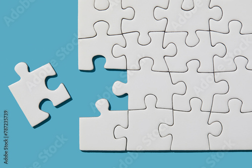 Jigsaw puzzle with missing piece on blue background