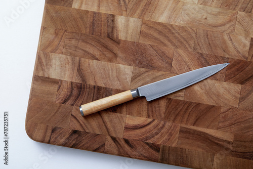 Overhead view of knife on wooden cutting board photo