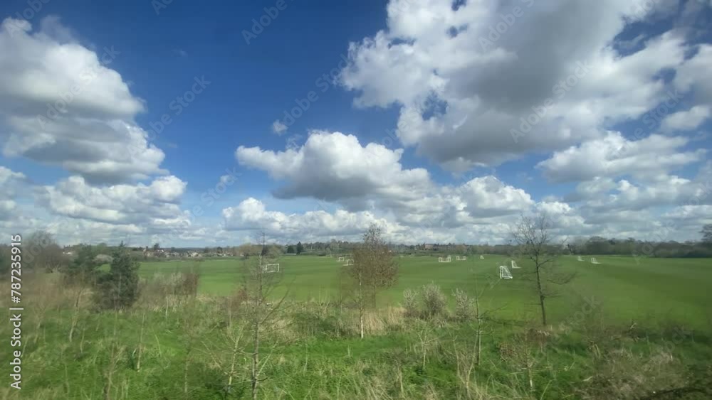 wide fields from train typical countryside in South England Kent sussex boarders Romney marsh area UK, flat blue sky - video footage wide fields from train typical countryside in South England Kent sussex boarders Romney marsh area UK, flat blue sky - video footage