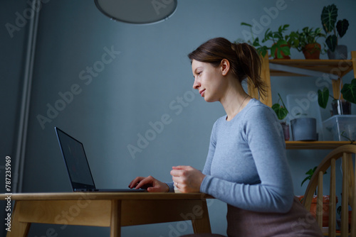 Woman using laptop at home