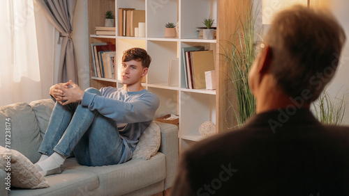 Psychological help. Male patient. Therapy session. Professional psychiatrist consulting inspired man sitting couch on psychotherapy appointment.